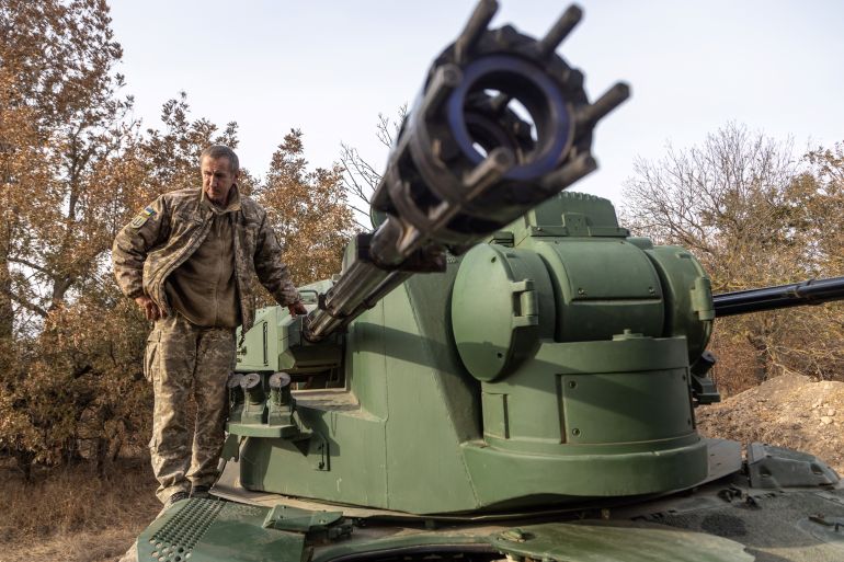A Ukrainian serviceman stands on German-made self-propelled anti-aircraft (SPAAG), known as the Flakpanzer Gepard, after military exercises in Odesa region on October 17, 2023, amid the Russian invasion in Ukraine. (Photo by Oleksandr GIMANOV / AFP)