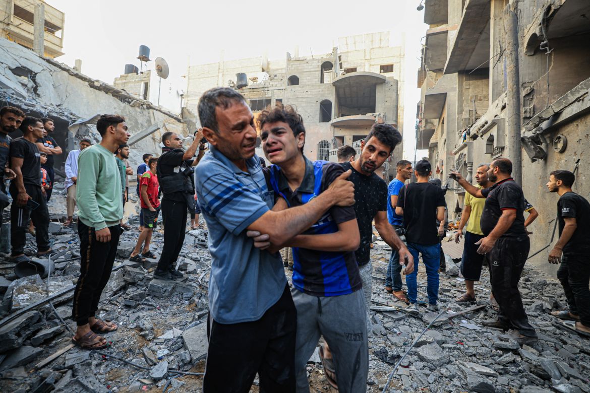 Palestinians civil look for survivors in the rubble of a building hit during Israeli bombardment in Khan Yunis