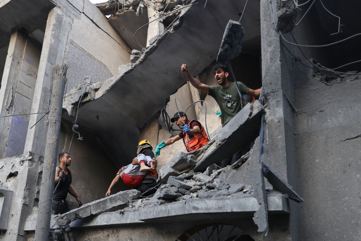 Palestinians civil look for survivors in the rubble of a building hit during Israeli bombardment in Khan Yunis