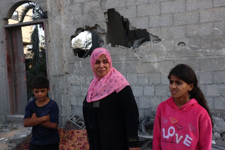 Palestinians react to the damage after overnight Israeli strikes on Rafah in the southern Gaza Strip on October 22, 2023
