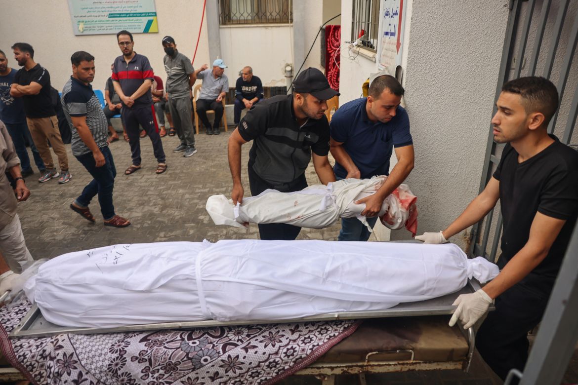 Medics transport the bodies of Palestinians killed in overnight Israeli bombardment in Rafah in the southern Gaza Strip