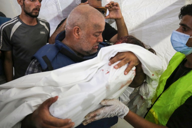 Al-Jazeera correspondent Wael Al-Dahdouh mourns over the body of one of his children
