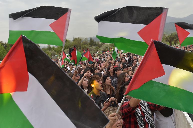 Protesters in Chile hold Palestinian flags amid the continuing bombardment of Gaza