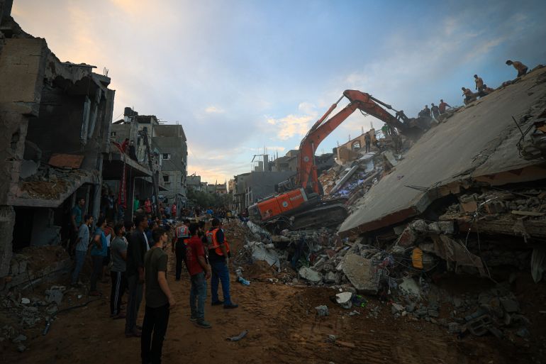 Palestinians search for survivors in the rubble of a building in the Nuseirat refugee camp, in the central Gaza Strip, on October 31, 2023, amid relentless Israeli bombardment