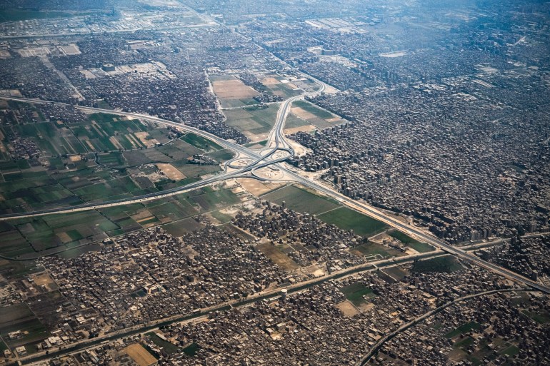 This picture taken on May 14, 2021 shows an aerial view of a highway intersection connecting between Egypt's main "Agricultural Road" highway connecting between the capital Cairo and the northern city of Alexandria, and the ringroad that circles around Cairo on its northern outskirts near Shubra al-Khayma in Qalyoubiyah province. (Photo by Amir MAKAR / AFP)