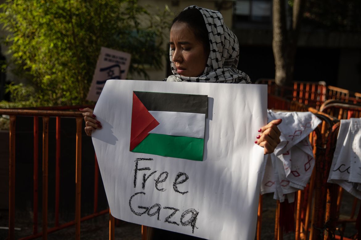 A woman holds a banner that says 'Free Gaza' in a Pro-Palestinian demonstration held in front of the Embassy of Israel to Mexico,