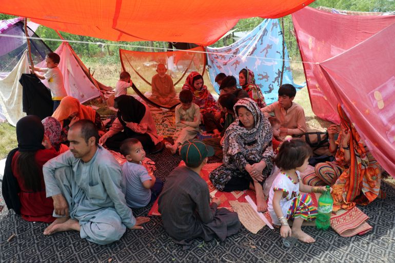 Afghan people rest as they have put up makeshift tents on the ground seeking to receive asylum from the United Nations High Commissioner for Refugees (UNHCR) outside the Islamabad Press Club in Islamabad, Pakistan, Monday, May 9, 2022. (AP Photo/Rahmat Gul)