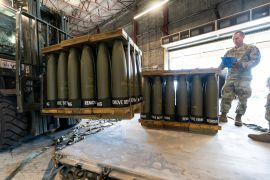 US Air Force Staff Sergeant Cody Brown checks pallets of 155mm shells ultimately bound for Ukraine [File: Alex Brandon/AP Photo]