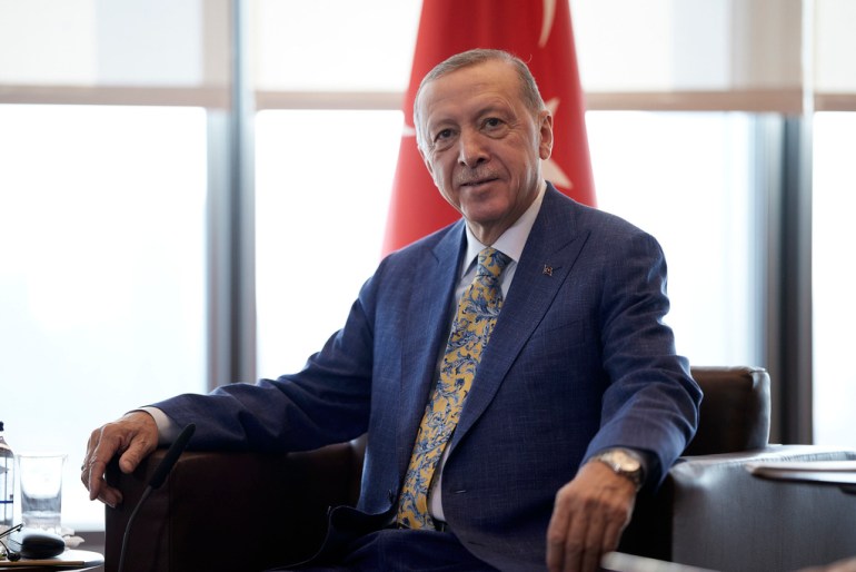 Turkish President Recep Tayyip Erdogan sits during a meeting