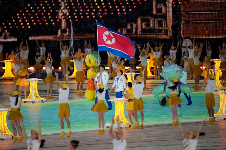 North Korean athletes carry their flag at the opening of the Asian Games