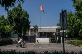 A cyclist pedals past the Afghan Embassy in New Delhi [Altaf Qadri/AP Photo]