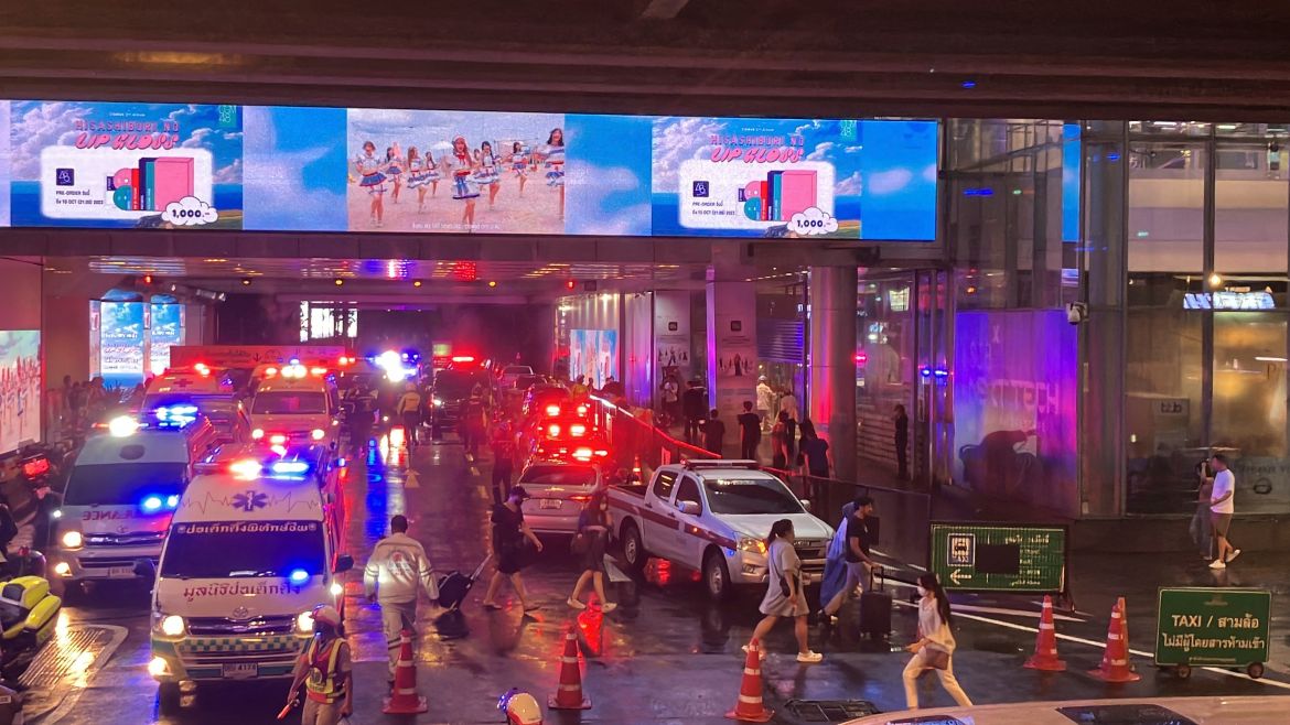 Ambulances wait outside an exit of the Siam Paragon Mall in Bangkok
