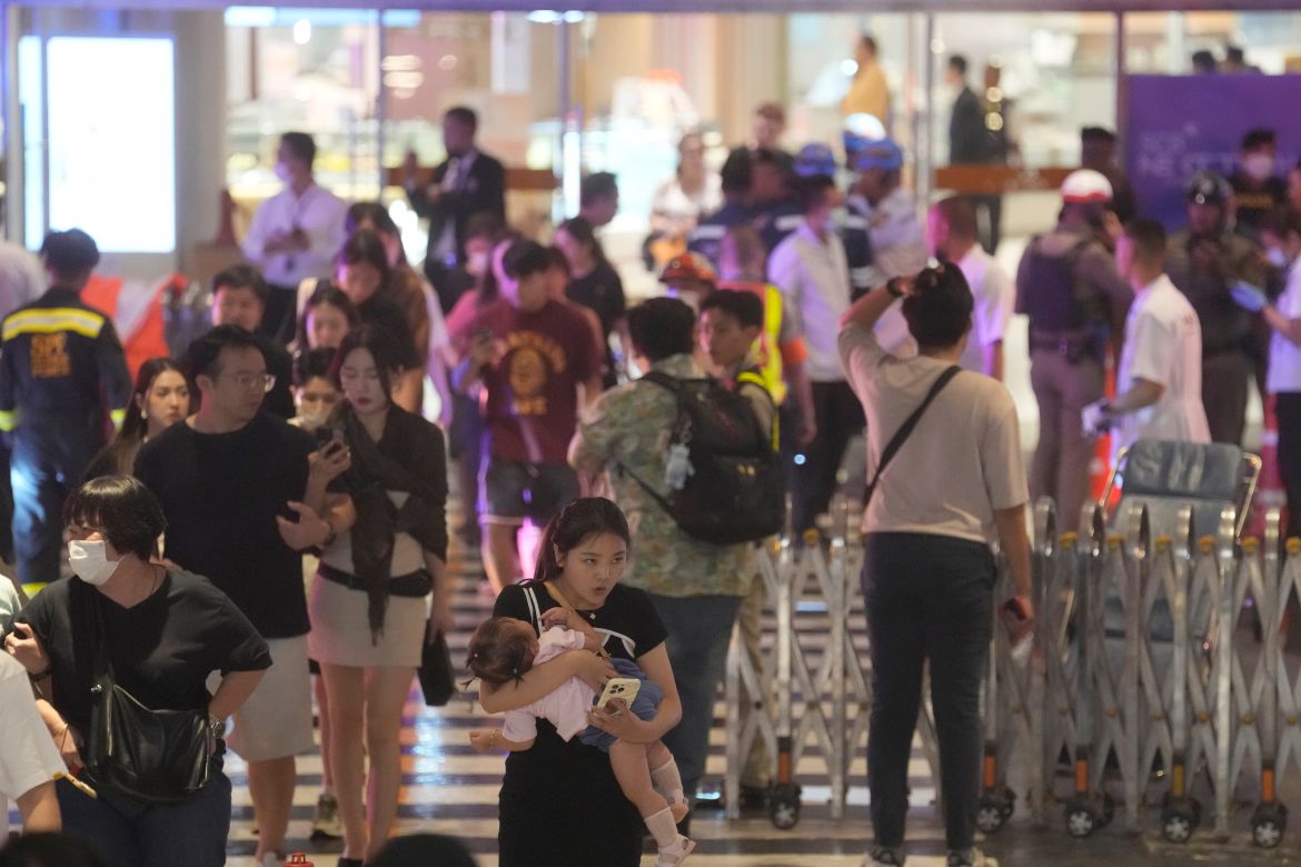 Tourists evacuate from a shopping mall in Bangkok, Thailand