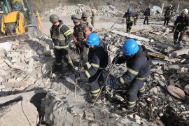 emergency workers search the victims of the deadly Russian rocket attack that killed more than 40 people in the village of Hroza near Kharkiv, Ukraine