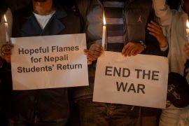 Students hold placards demanding Nepalese government ensure the safe return of stranded students and light candles in Patan Durbar Square, Lalitpur, Nepal, as they pay tribute to Nepali nationals who lost their lives in the fighting in Israel, Monday, Oct. 9, 2023. Ten Nepali nationals have been killed in fighting in Israel and at least one more is missing, Nepal’s Foreign Ministry said. An unknown number of others were wounded in the violence, it added. (AP Photo/Niranjan Shrestha)