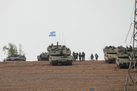 Israeli soldiers are seen in a staging ground near the Israeli Gaza border, southern Israel
