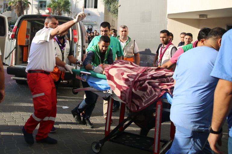 Palestinian wounded in Israeli strikes is brought to Shifa Hospital in Gaza City