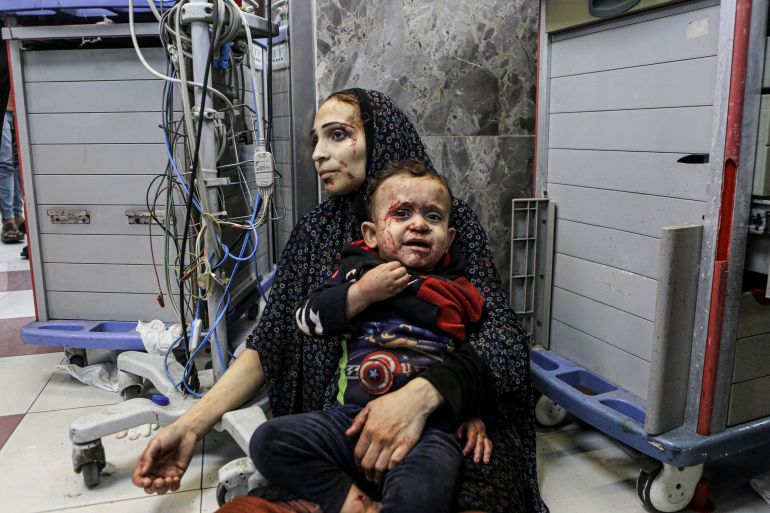 Wounded Palestinians wait for treatment, at the al-Shifa hospital