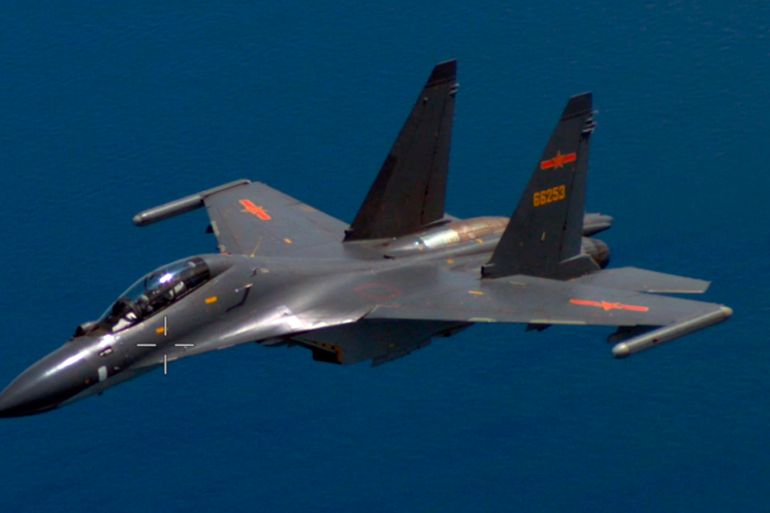 A Chinese fighter jet pictured from a US plane over the Pacific