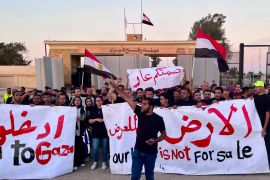 Egyptian volunteers shout anti-Israel slogans at the Rafah crossing port, Egypt, Wednesday, Oct. 18, 2023. (AP Photo/Omar Aziz)
