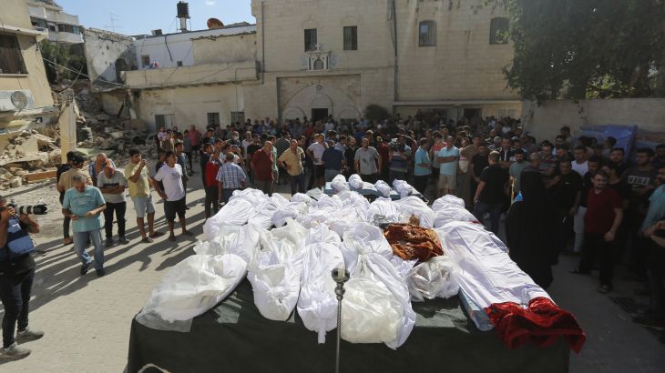 Relatives attend the funeral of Palestinians who were killed in Israeli airstrikes that hit a church, in Gaza City