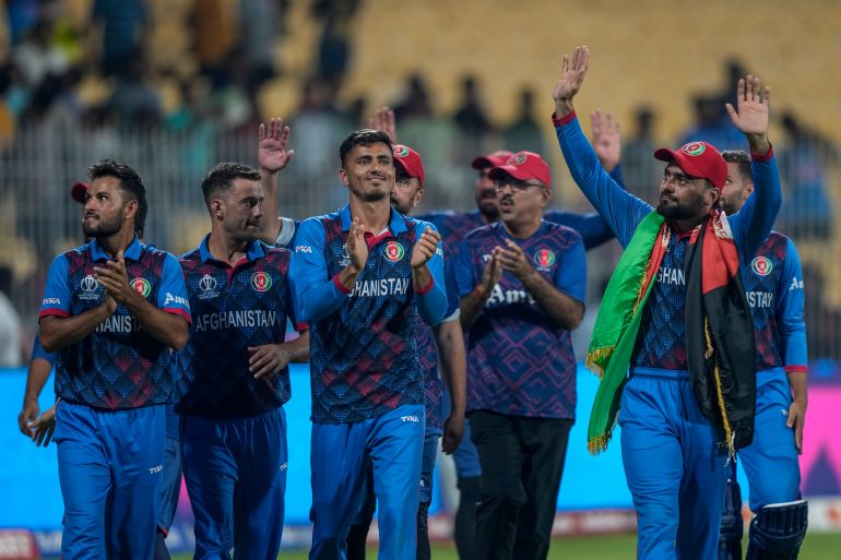 Afghanistan's players acknowledge the crowd after winning their match against Pakistan during the ICC Men's Cricket World Cup in Chennai, India