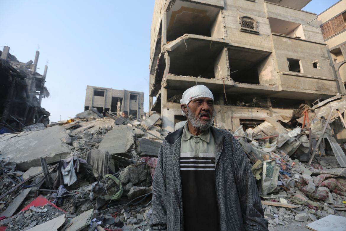 A Palestinian stands outside the building destroyed i the Israeli bombardment of the Gaza Strip in Rafah,