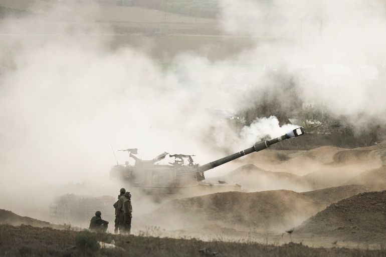 Israeli mobile artillery unit fires a shell from southern Israel towards the Gaza Strip