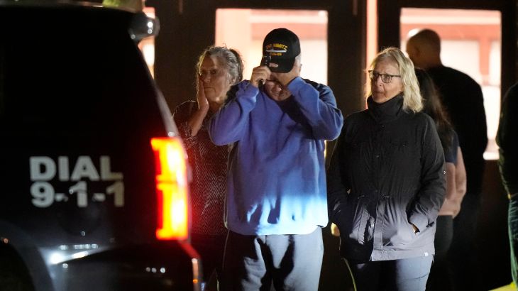 People depart a reunification center early Thursday, Oct. 26, 2023, at Auburn Middle School, in Auburn, Maine, after shootings in Lewiston