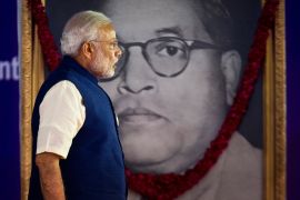 Indian Prime Minister Modi walks by a photograph of Dalit icon and architect of India&#39;s constitution Bhimrao Ambedkar during the unveiling ceremony of the foundation stone for an international centre dedicated to Ambedkar in New Delhi on April 20, 2015. [Saurabh Das/AP Photo]