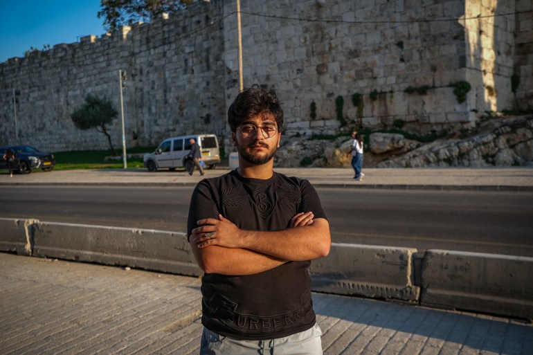 Adnan standing in front of the walls of the Old City that he now worries about crossing
