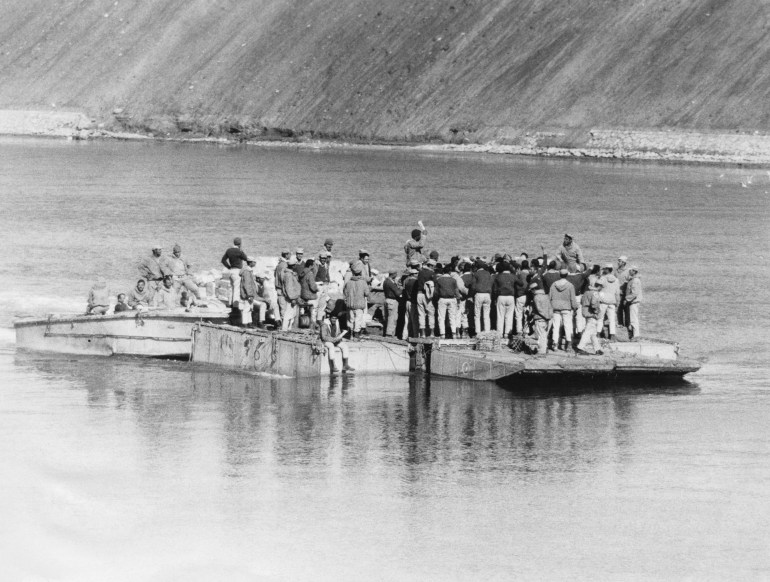 Egyptian soldiers transport food across the Suez Canal to the members of their Third Army, from the Egyptian side of Suez
