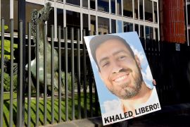 Posters depicting Khaled El Qaisi, with the words: Free Khaled, in front of the headquarters of the Italian Radio and Television demanding his release [File: Simona Granati/Corbis via Getty Images]