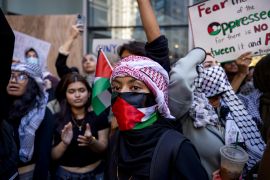 Students from Hunter College chant and hold up signs during a pro-Palestinian demonstration at the entrance of their campus