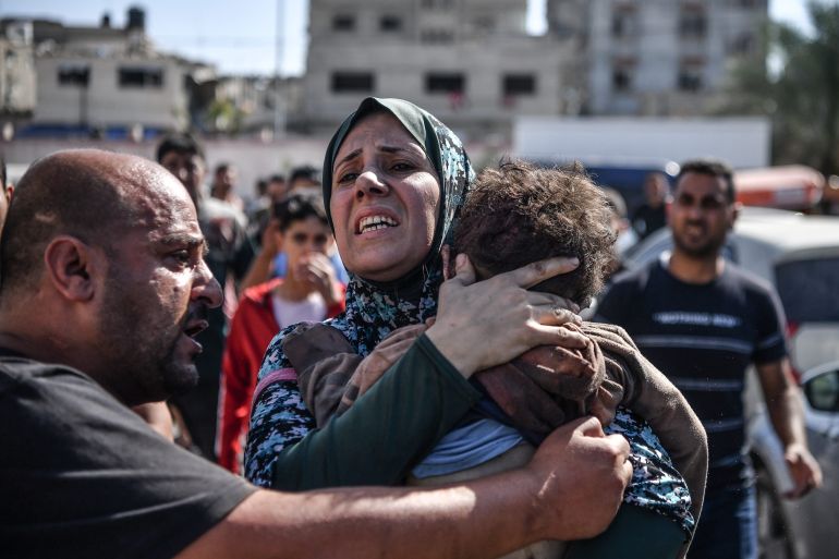 A woman in Gaza holds her 3 year-old son