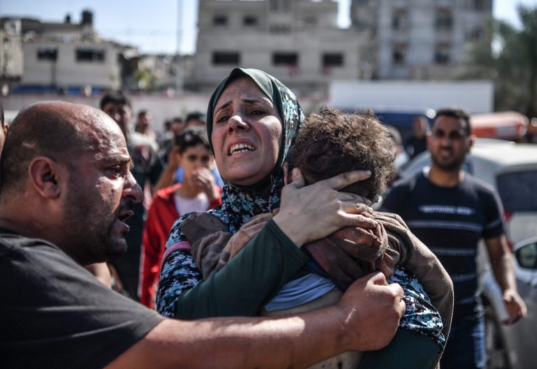 A woman in Gaza holds her 3 year-old son