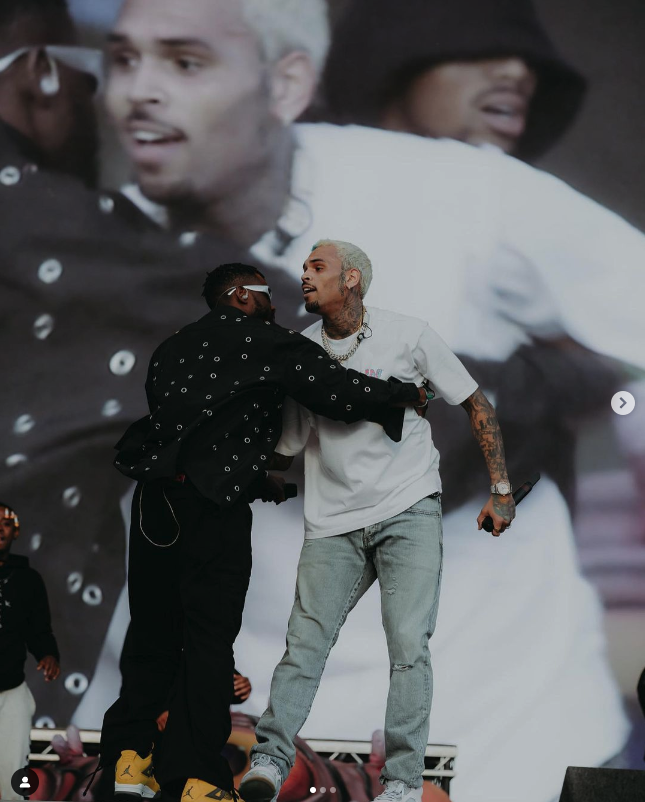 Singers Lojay and Chris Brown hug after performing their song Monalisa Remix, together