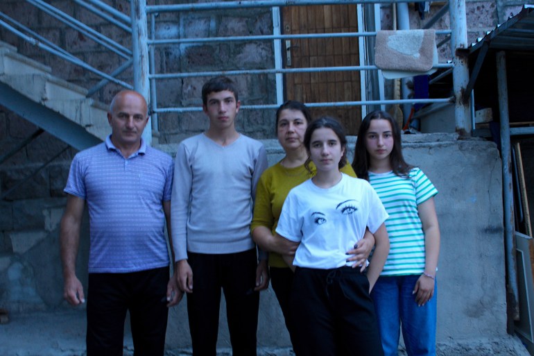 The Ghazaryan family in front of their friend's house just outside Yerevan, where they are now staying after fleeing their home in Kachmach village, Nagorno-Karabakh. From left: Artyom, Aren, Ina, Inessa, and Alisa-1696579925