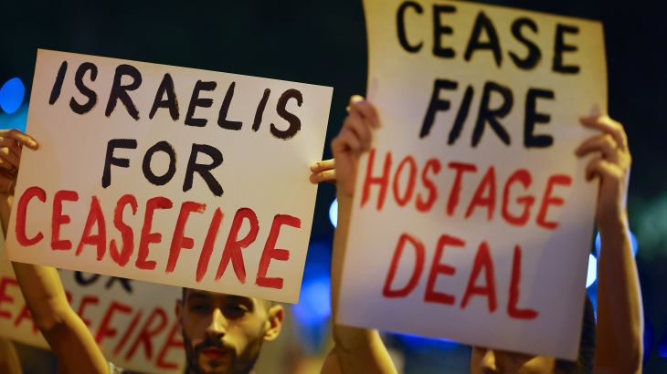 People hold placards as left wing supporters call for a ceasefire to allow negotiations following the escalation of the Israel-Hamas conflict, during a rally in Tel Aviv, Israel