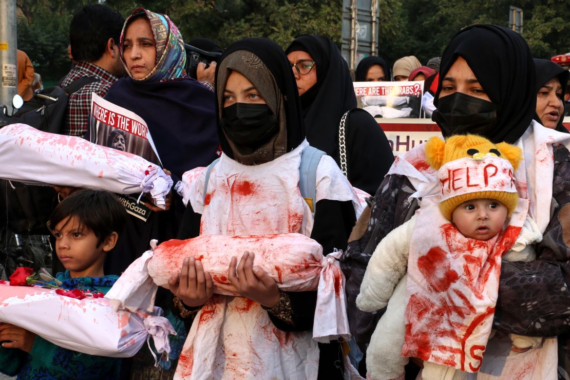 People hold mock bodies symbolizing dead Palestinian children during a demonstration on the International Day of Solidarity with the Palestinian People, in Islamabad, Pakistan.