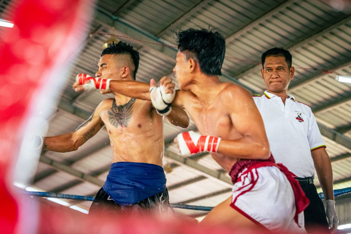 Sweat flies off Myint Myat Hein’s face as he takes a jab from his opponent, a fighter from Daung Myanmar Club. Sunday 13 August 2023.
