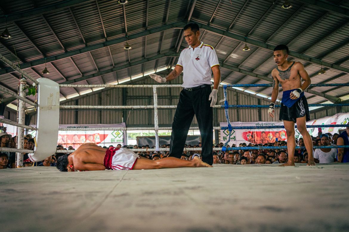 Myint Myat Hein looks on concerned after knocking down his opponent, earning a victory and 50,000 Myanmar kyat ($15) in prize money.