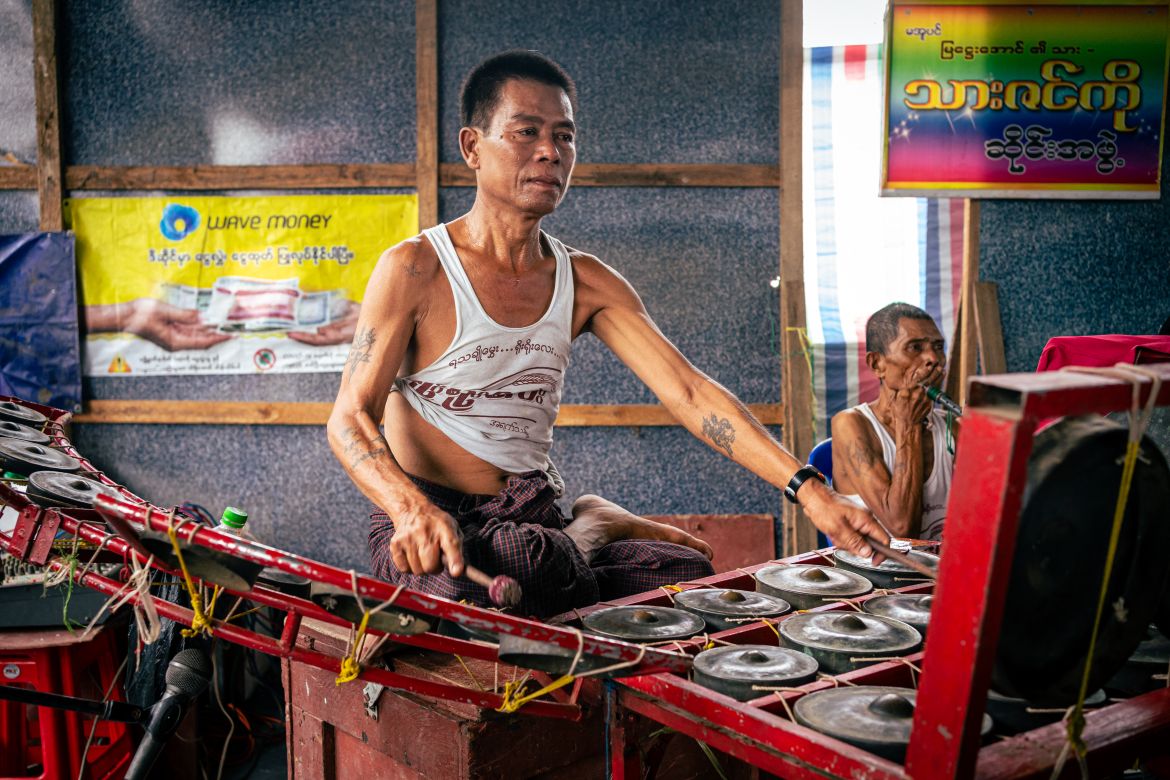 A member of the traditional Myanmar hsaing waing hits his cymbals to match the intensity of the fight.