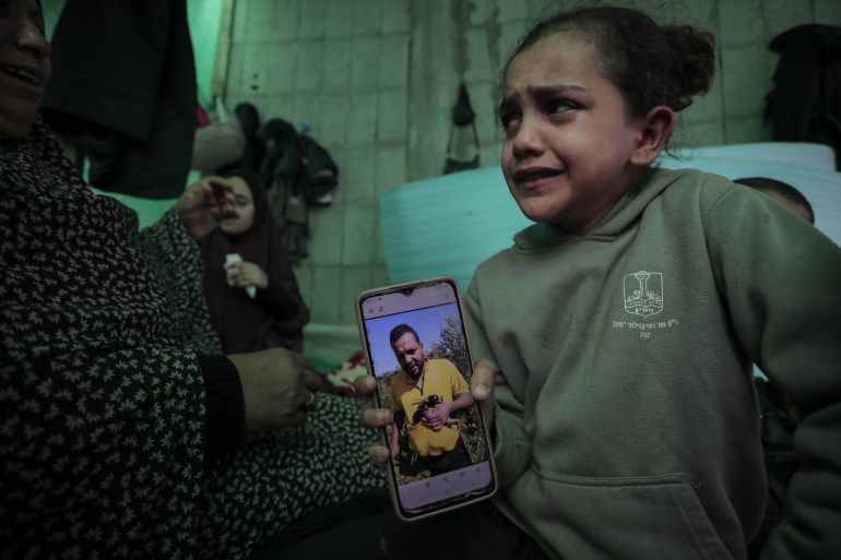 Zahwa al-Samouni shows a photo of her father Faraj, who was kidnapped by Israeli soldiers on November 16