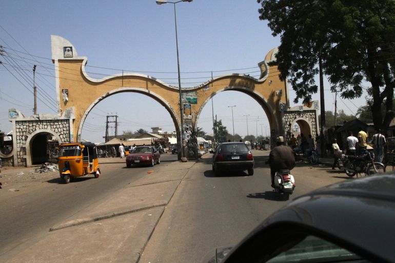 Motorists drive past the Bauchi city gate