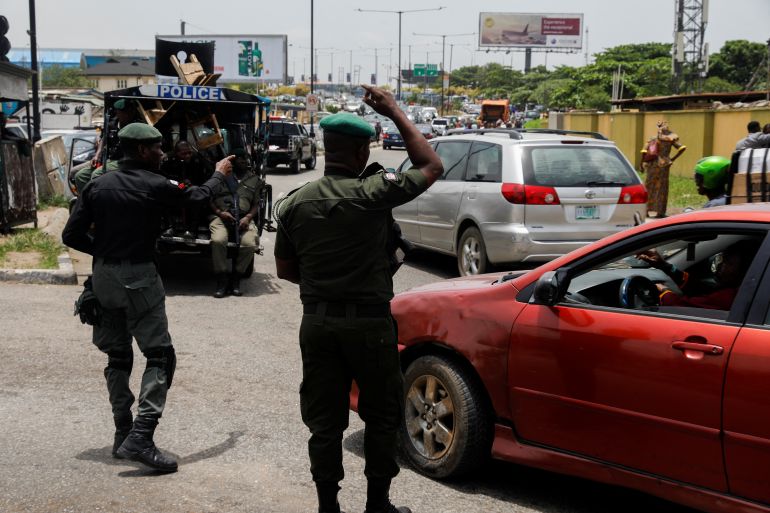 Police officers control traffic during a Lagos protest
