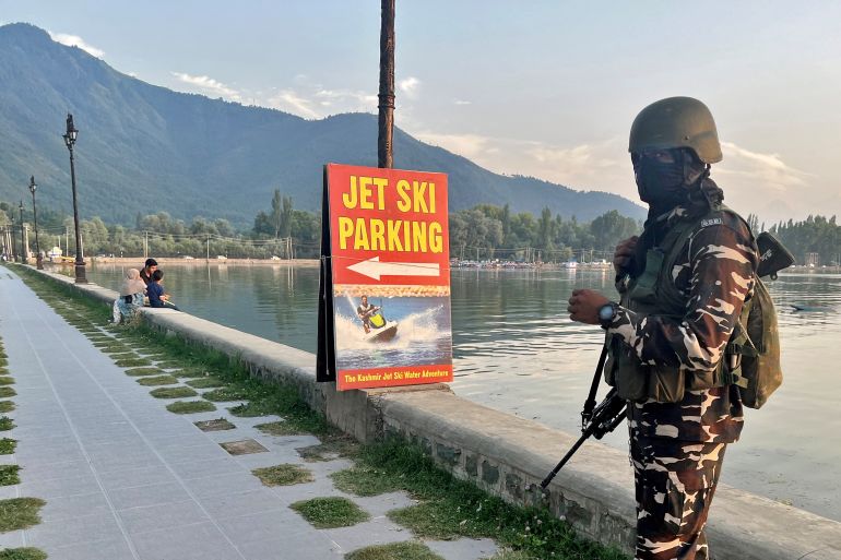 An Indian security force personnel stands guard on the banks of Dal Lake, one of Kashmir's main tourist attractions, in Srinagar, India July 6, 2023. REUTERS/Altaf Hussain
