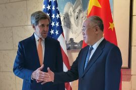 U.S. Special Presidential Envoy for Climate John Kerry shakes hands with his Chinese counterpart Xie Zhenhua before a meeting in Beijing