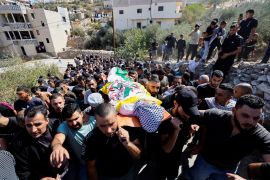 Mourners at a funeral carry the body of a 16-year-old Palestinian teen killed in clashes with Israeli forces, near Hebron in the Israeli-occupied West Bank on October 12, 2023 [Mussa Qawasma/Reuters]