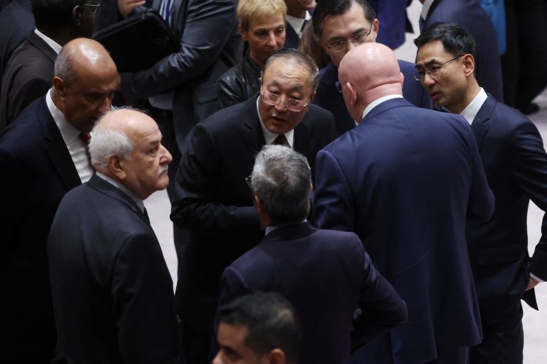 China's Ambassador to the UN Zhang Jun talking to Russia's UN envoy Vassily Nebenzia and Riyad H Mansour, Permanent Observer of Palestine to the UN. They are standing in a small group and the discussion looks quite animated.